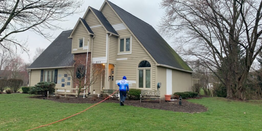 Pressure washing a residential home exterior in Fishers, IN