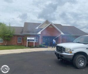 house washing technician soft washing soffits and roofline siding
